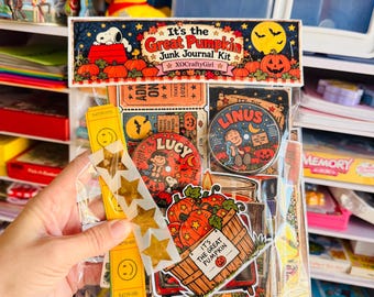 May include: A clear plastic bag containing an It's the Great Pumpkin junk journal kit. The kit includes paper ephemera, a Lucy button, a Linus button, yellow smiley face tickets, gold star stickers, and a pumpkin crate cutout with text.