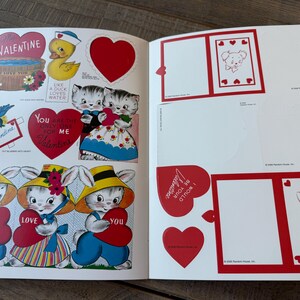 May include: Open book with vintage Valentine's Day illustrations. Features include a duck in a sailor hat, kittens, bunnies holding hearts, and heart-shaped cutouts. The text includes "Valentine" and "I love you."