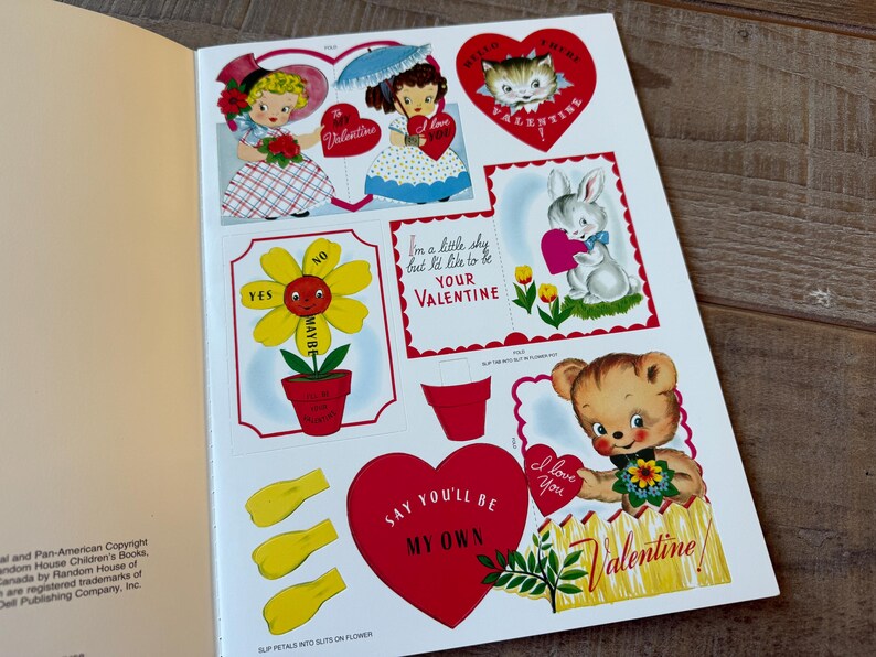May include: A vintage Valentine's Day sticker sheet with illustrations of a flower, a kitten, a bunny, and a teddy bear. The designs are in red, white, and yellow, with Valentine's Day messages. The sheet is from a children's book.