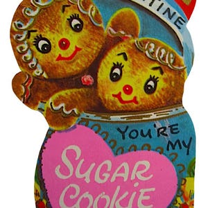 May include: A vintage Valentine's Day card showing two gingerbread people in a blue jar. The card has a pink heart with the words "Sugar Cookie" and the phrase "You're my". The word "Valentine" is at the top.