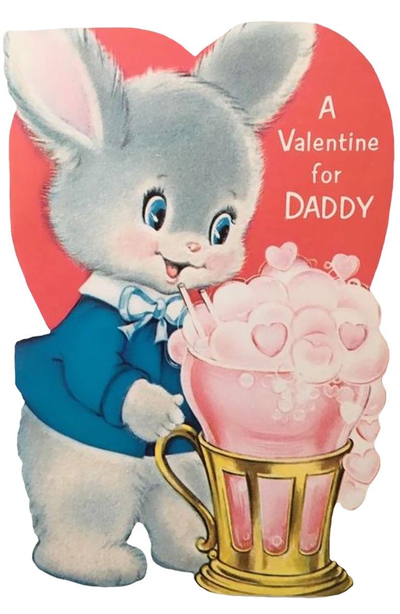 May include: Vintage Valentine's Day card featuring a cartoon bunny in a blue jacket and bow tie. The bunny holds a pink drink with heart-shaped foam in a gold cup. Text on the red heart background reads "A Valentine for DADDY."