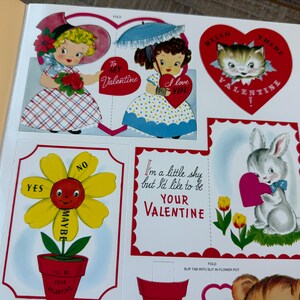 May include: A selection of vintage Valentine's Day cutouts. The illustrations include children, a cat, and a bunny, all holding hearts. Text includes "To My Valentine" and "I love you". A flower cutout offers "Yes", "Maybe", and "No" options.