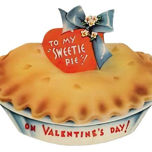May include: A vintage Valentine's Day card in the shape of a pie. The pie has a golden-brown crust and sits in a white and blue dish. A red heart with the words "TO MY 'SWEETIE PIE'" is attached to the pie with a blue bow and small flowers. The words "ON VALENTINE'S DAY!" are written on the dish.