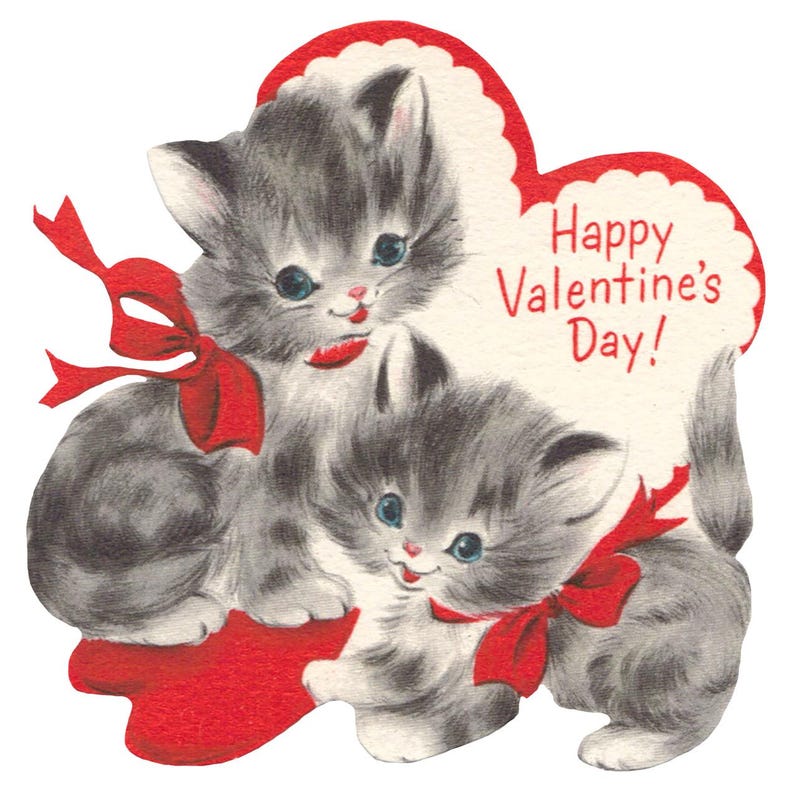 May include: Vintage Valentine's Day card featuring two gray kittens with red bows. The kittens are set against a red heart-shaped background with the text "Happy Valentine's Day!" in red.
