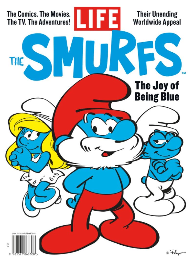Puede incluir: Una portada de revista con los Pitufos. La portada tiene el t&iacute;tulo "LIFE" en rojo, con la palabra "SMURFS" en letras azules grandes. Se muestran tres personajes de los Pitufos, con el texto "The Joy of Being Blue".