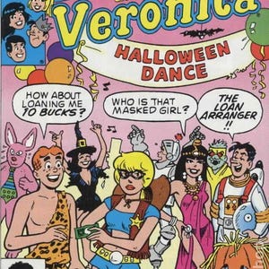 May include: Comic book cover for "Betty and Veronica Halloween Dance." The image features a pink background with the title in yellow and blue. Characters in costumes are shown, with speech bubbles. The comic is marked as Archie Series No. 46.