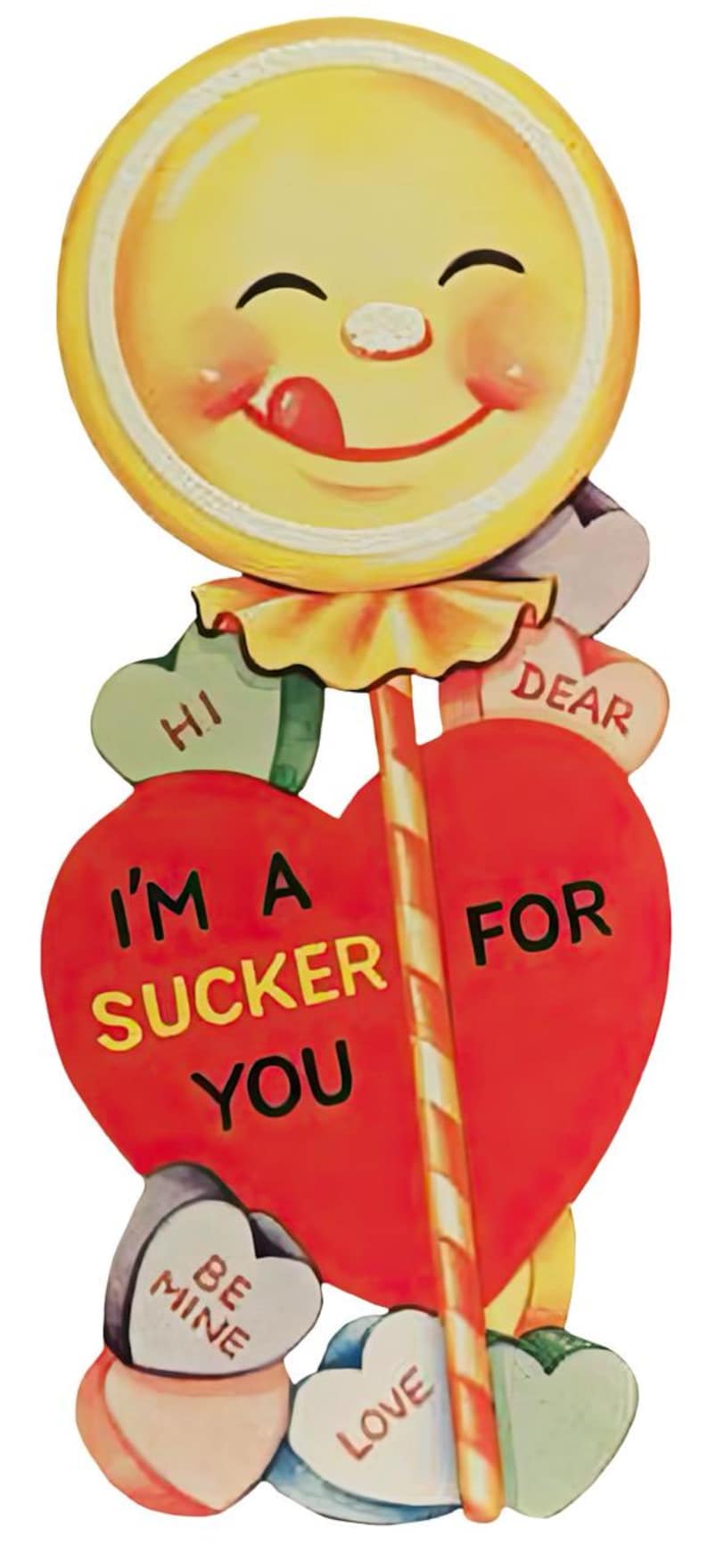 May include: A retro Valentine's Day lollipop decoration. The lollipop features a smiling face and the text "I'M A SUCKER FOR YOU". Heart-shaped candies say "HI", "DEAR", "BE MINE", and "LOVE".