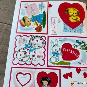 May include: A sheet of vintage Valentine's Day cutouts with illustrations of a puppy, a cat, and a bunny. The designs include hearts, bows, and the phrases "I love you" and "Be Mine."