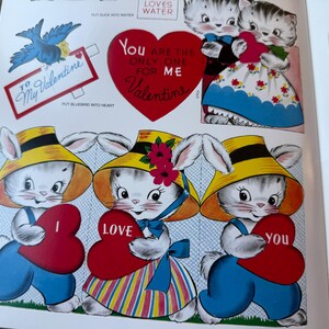 May include: Vintage Valentine's Day cutouts with cartoon kittens and bunnies. The illustrations include a blue bird, a heart-shaped message that reads "You are the only one for me Valentine", and other heart-shaped cutouts. The characters are holding heart-shaped cards.