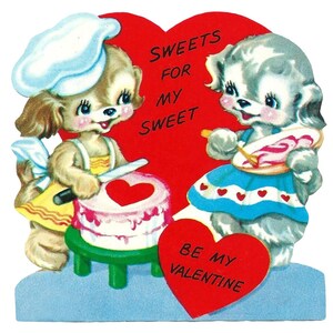 May include: A vintage Valentine's Day card featuring two cartoon puppies. One puppy cuts a cake with a heart on top, while the other adds frosting. Text on the card reads "Sweets for my Sweet" and "Be My Valentine."