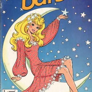 May include: Comic book cover featuring Barbie sitting on a crescent moon, surrounded by stars. Barbie wears a pink dress with white stars and matching heels. The title "Barbie" is in large yellow letters.