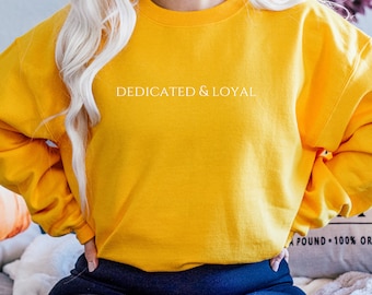 May include: A yellow sweatshirt with the text "DEDICATED & LOYAL" printed in white on the front.