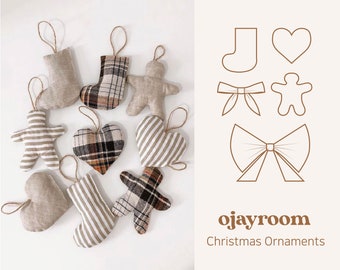 May include: A set of nine handmade Christmas decorations featuring a variety of shapes and patterns. The decorations are made of fabric and include a heart, a stocking, a gingerbread person, and a bow. The decorations are all beige and brown with plaid and striped patterns. The decorations are hanging from a white background. The text "ojayroom Christmas Ornaments" is visible in the bottom right corner of the image.