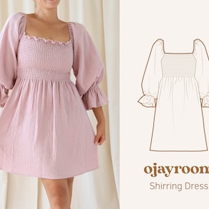 May include: A light pink shirring dress with a square neckline and puffed sleeves. The dress has a fitted bodice and a flowy skirt. The dress is shown on a model in front of a white background. The text "ojayroom Shirring Dress" is shown in brown text on a white background.