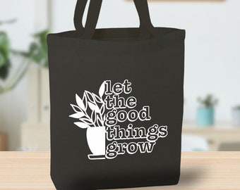 May include: A black tote bag with a white design featuring a potted plant and the text "let the good things grow".