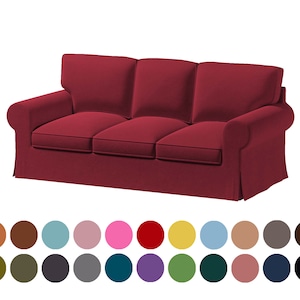 May include: A three-seater sofa with a burgundy fabric cover. The sofa has a tufted back and rolled arms. The sofa is sitting on a white background.