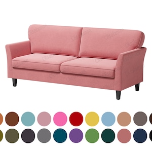 May include: A pink fabric sofa with two cushions and wooden legs.