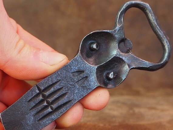 A blacksmith hammered a human face into a bottle opener — it's functional folk art you'll actually use.