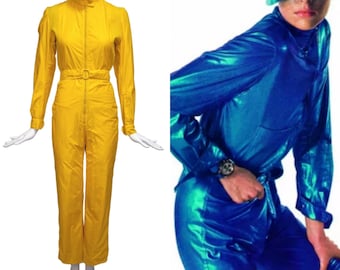 May include: Two women's jumpsuits, one yellow and one blue. The yellow jumpsuit has a zipper down the front and a belt. The blue jumpsuit has a shiny, metallic finish.