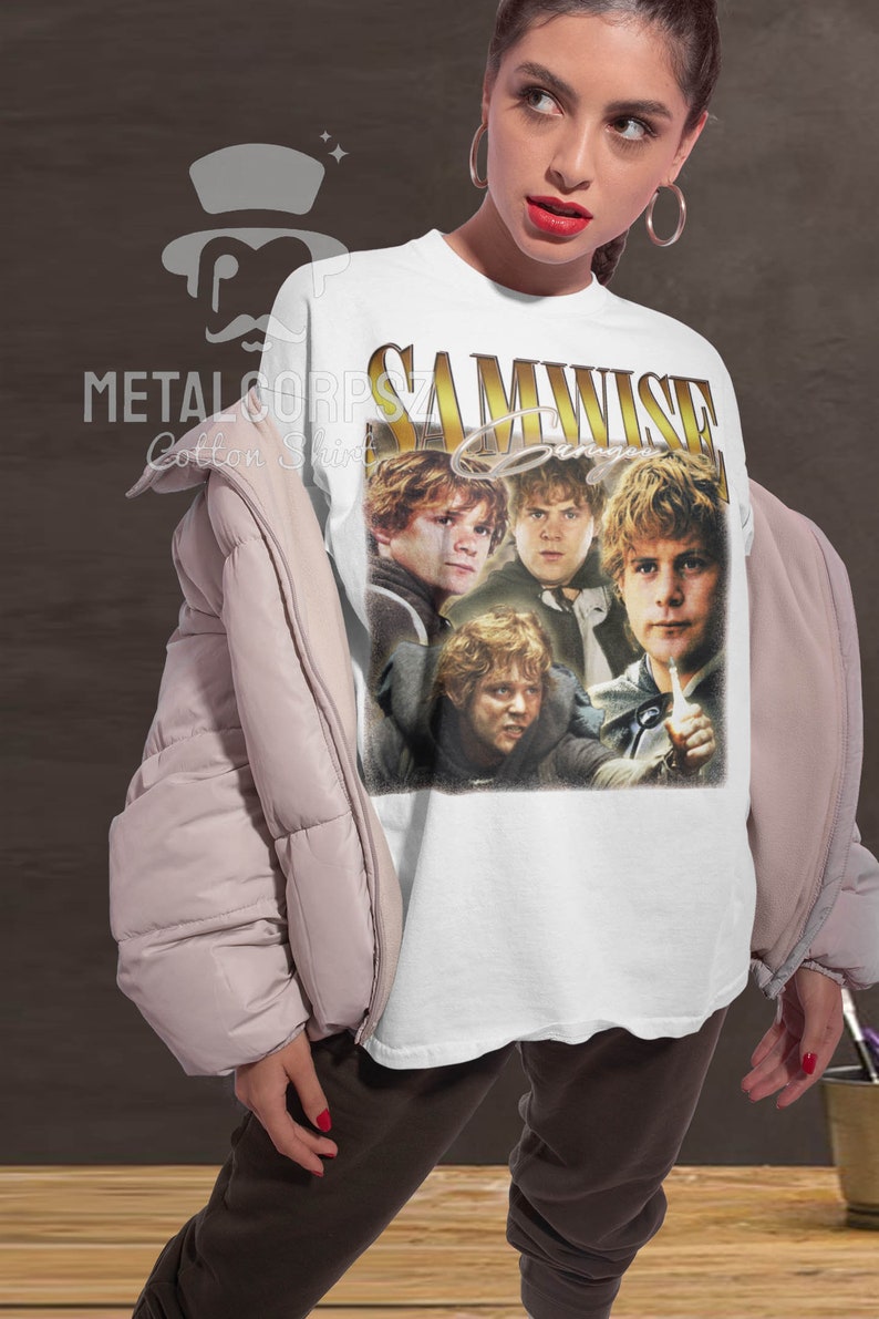 May include: White t-shirt with a vintage-style graphic of Samwise Gamgee from the Lord of the Rings. The graphic features four images of Samwise Gamgee in different poses. The text "SAMWISE Gamgee" is written in gold letters above the images.