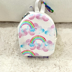 May include: A set of three ceramic mugs with a speckled, matte finish. Each mug features a different color: light blue, cream, and gray. The mugs have a simple, modern design and a comfortable handle.