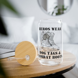 May include: A clear glass can with a bamboo lid and a straw. The can has a black and white graphic of combat boots and dog tags with the text "HEROS WEAR DOG TAGS & COMBAT BOOTS".