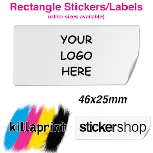 May include: White rectangular sticker with the text "YOUR LOGO HERE" and the dimensions 46x25mm. The sticker is shown with a curled corner. The text "killaprint" is shown in colourful paint strokes and the text "stickershop" is shown on a white sticker with a curled corner.