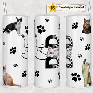 May include: Three white stainless steel tumblers with black paw prints and cat images. The tumblers are 20 ounces and have a straw.