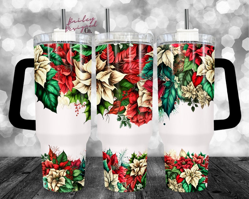 May include: A white stainless steel tumbler with a black handle and a lid. The tumbler features a Christmas-themed design with red and white poinsettia flowers, green leaves, and red berries.
