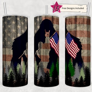 May include: A set of three stainless steel tumblers with a patriotic design. The tumblers feature a silhouette of a bear holding an American flag, with a wood grain background. The design is repeated on all three tumblers.