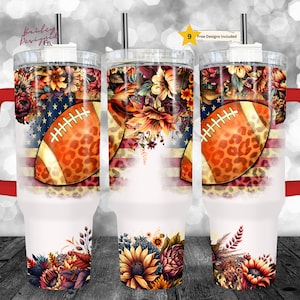 May include: A set of three insulated tumblers with a football design. The design features a football with a leopard print pattern, floral arrangements, and an American flag motif. Each tumbler has a red handle and a straw.