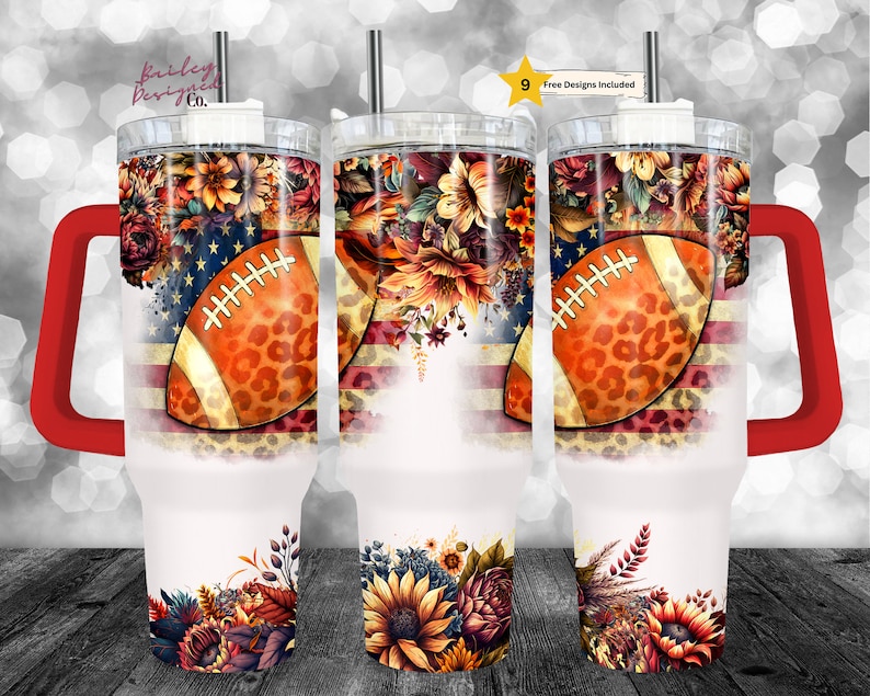 May include: A set of three insulated tumblers with a football design. The design features a football with a leopard print pattern, floral arrangements, and an American flag motif. Each tumbler has a red handle and a straw.