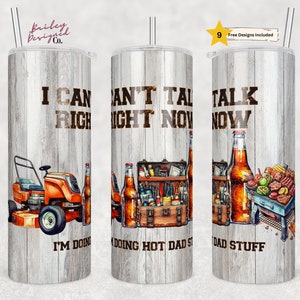 May include: Three stainless steel tumblers with a wood grain design. The tumblers feature different designs with the text "I can't talk right now I'm doing dad stuff" and images of a lawnmower, tools, and a grill.