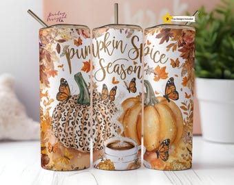 May include: Three stainless steel tumblers with a white background and fall-themed designs. The tumblers feature pumpkins, butterflies, and leaves in shades of orange, brown, and gold. The text "pumpkin spice season" is printed in gold on the middle tumbler.