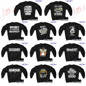 May include: A collage of ten black sweatshirts with various graphic designs and text. The sweatshirts are paired with black and white sneakers. The designs include "A Little Classy A Little Hood", "0% Luck 100% Off The Muscle", "Money Power Respect", "Married To The Game", "Money Talks", "Legendary", "Hustle", "Fear No Man But God", "Glee", and "Hood AF".
