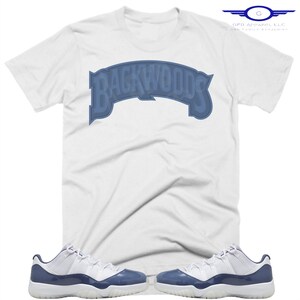 May include: White t-shirt with a blue "Backwoods" logo and a pair of white and blue Air Jordan 11 Retro sneakers.