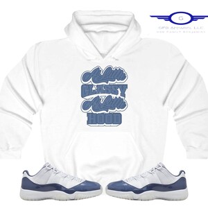 May include: White hoodie with a blue graphic that says "A Little Classy A Little Hood".  A pair of white and blue sneakers are also pictured.