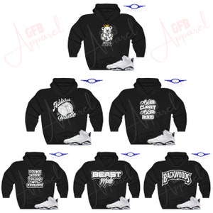 May include: Six black hoodies with different white graphic designs and a pair of white trainers. The hoodies feature designs such as "Addicted to Hustle", "A Little Classy A Little Hood", "Count Your Blessings Not Your Problems", "Beast Mode", and "Backwoods".