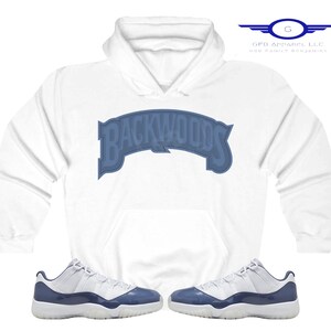 May include: White hoodie with a blue "Backwoods" logo and a pair of white and blue Air Jordan 11 sneakers.