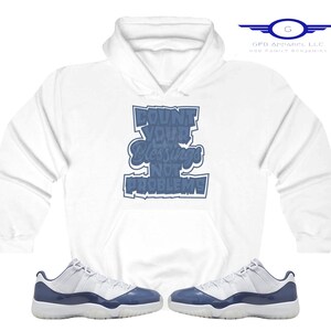 May include: White hoodie with a blue graphic that says "Count Your Blessings Not Problems".  A pair of white and blue sneakers are also pictured.