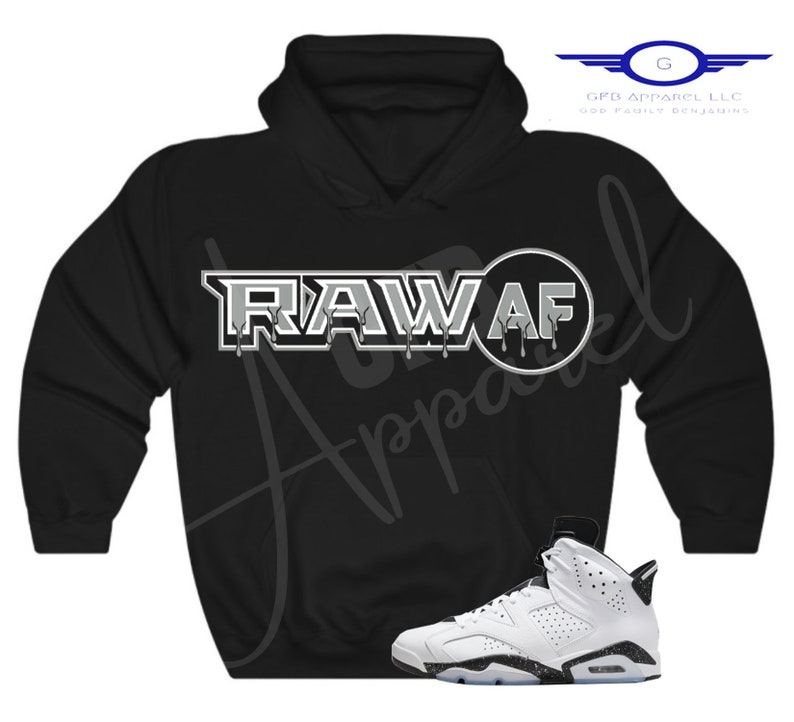 May include: Black hoodie with a white graphic that says "RAW AF" and a white and black trainer.