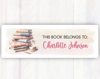 May include: A bookplate with a stack of books, a cup of coffee, and a pencil. The text reads "This book belongs to: Charlotte Johnson".