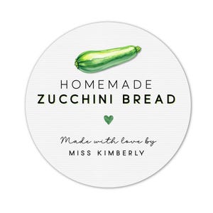 May include: A round white label with the words "HOMEMADE ZUCCHINI BREAD" in black text. A green zucchini illustration is at the top, with a green heart below the text. The words "Made with love by MISS KIMBERLY" are at the bottom.