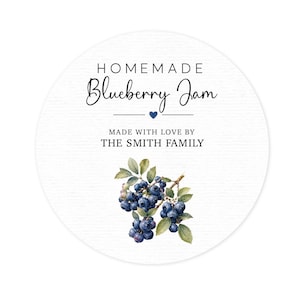 May include: A circular white label featuring the text HOMEMADE Blueberry Jam, a small blue heart, and the text MADE WITH LOVE BY THE SMITH FAMILY. Below the text is a watercolor illustration of a cluster of dark blue blueberries on a green stem.