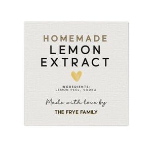 May include: A square, off-white label with the words "HOMEMADE LEMON EXTRACT" in a mix of gold and black fonts. Below the text is a gold heart. The ingredients are listed as lemon peel and vodka. The text "Made with love by THE FRYE FAMILY" is at the bottom.