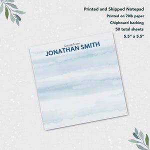 May include: A blue and white watercolor notepad with the text "a note from JONATHAN SMITH" printed on the front. The notepad is 5.5 inches by 5.5 inches and has 50 sheets of 70lb paper.