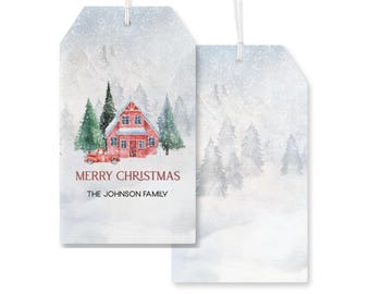 May include: Red Christmas gift tag with a watercolor illustration of a red house with snow-covered trees and a red truck in front of it. The text on the tag reads "Merry Christmas" and "The Johnson Family".
