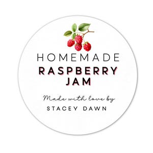 May include: Round white sticker with black text that reads "HOMEMADE RASPBERRY JAM" and "Made with love by STACEY DAWN". A watercolor illustration of a raspberry branch with red raspberries is above the text.