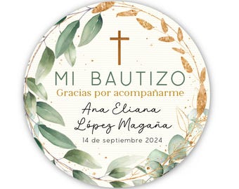 May include: A round, white card with a gold and green wreath border. The card says "Mi Bautizo" with a cross above the text. The text "Gracias por acompañarme" is below the cross. The name "Ana Eliana López Magaña" is below the text. The date "14 de septiembre 2024" is below the name.