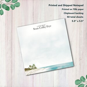 May include: A white notepad with a blue and green beach scene on the bottom. The notepad has a chipboard backing and 50 sheets. The text "A Note From Sean Colby Frye" is printed at the top of the notepad.